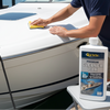 Man cleaning a boat with a bottle of CarPro cleaner wax in the foreground.