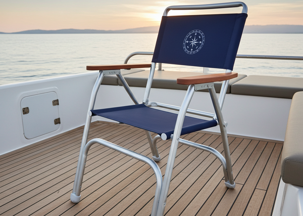 Chair with a blue backrest on a boat deck during sunset.