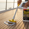 Person cleaning a boat deck with teak cleaner and scrubber
