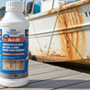 Rust-Off rust remover bottle on a dock with a rusty boat in the background