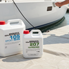 Person working with epoxy resin and hardener containers near a boat on a dock.