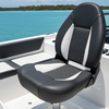 Black and white boat seat on a boat with water and sky in the background