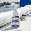 Spray bottle of Starbrite Waterproofing on a sailboat with a person in the background.