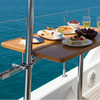 Table on a boat with food and drinks against a blue ocean and sky