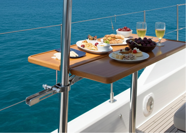 Table on a boat with food and drinks against a blue ocean and sky