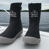 Black Octi Boot socks on a boat with water and sky in the background