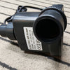 Black electric air pump on a textured surface