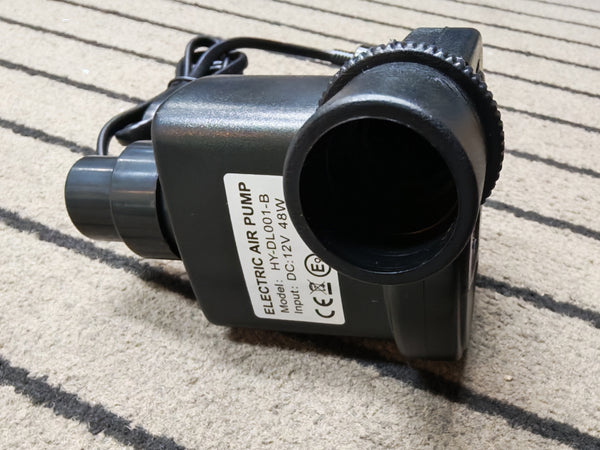 Black electric air pump on a textured surface