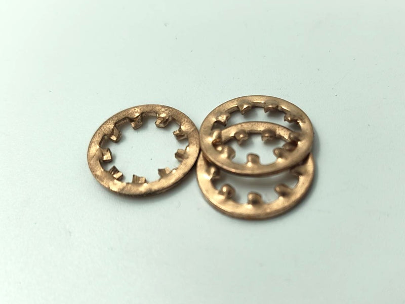 Two bronze washers on a light blue background