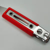 Red and silver utility knife on a light gray background