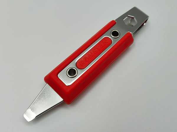 Red and silver utility knife on a gray background