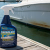 A bottle of Star Brite Ultimate Fiberglass Stain Remover spray, featuring a dark blue bottle and white trigger sprayer against a light gray background.
