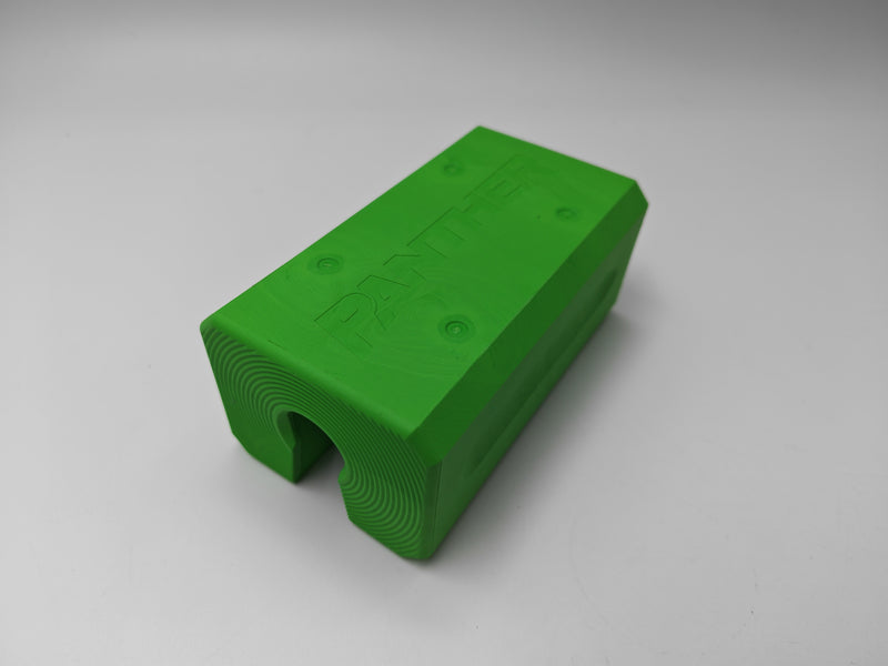 A bright green 3D-printed rectangular block with a curved cutout on one end, featuring the embossed brand name 'PANTHER' on top, set against a neutral gray background.