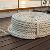 Coiled rope on a ship's deck with a sunset over the ocean in the background