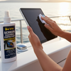 Person cleaning a tablet on a boat with Star Brite Screen Cleaner & Protectant.