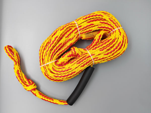Yellow and red rope with a black handle on a gray background