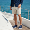 Man standing on a yacht with ocean in the background