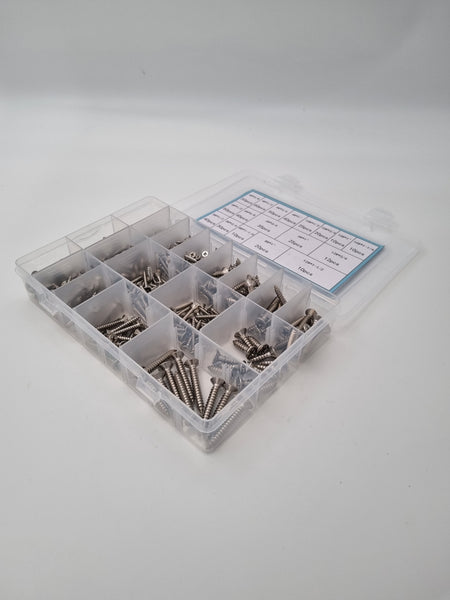 Angled photo of screws in a lightbox inside a box with seperate compartments 
18 different size screws