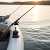 Man fishing from a boat on a calm lake at sunset