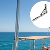Person sitting on a boat with a table and a close-up of a metal clip against a blue sky and ocean background.