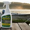 Star brite mold and mildew stain blocker spray bottle on a wooden dock with a boat and lake in the background.