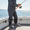 Woman fishing on a boat with a clear blue sky and ocean background