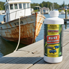 Rust converter bottle on a dock with a rusty boat in the background