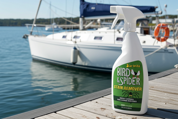 Bird & Spider stain remover bottle on a dock with a sailboat in the background