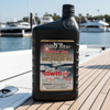 Sunvic Pro Star outboard motor oil bottle on a boat deck with marina background