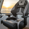 Marine chair on a boat with a sunset view through the windows.