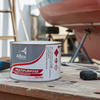 Altex multipurpose primer coat can on a workbench with a boat in the background