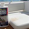 Star Brite Vinyl Cleaner & Shampoo bottle on a boat with a marina background
