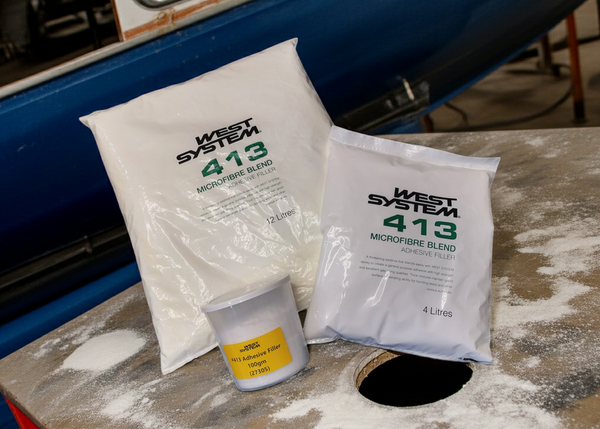 West System 413 microfibre blend bags and container on a workbench.