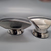 Two metallic vent cowl scoops on a gray background