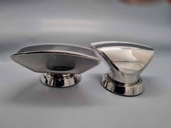 Two metallic vent cowl scoops on a gray background